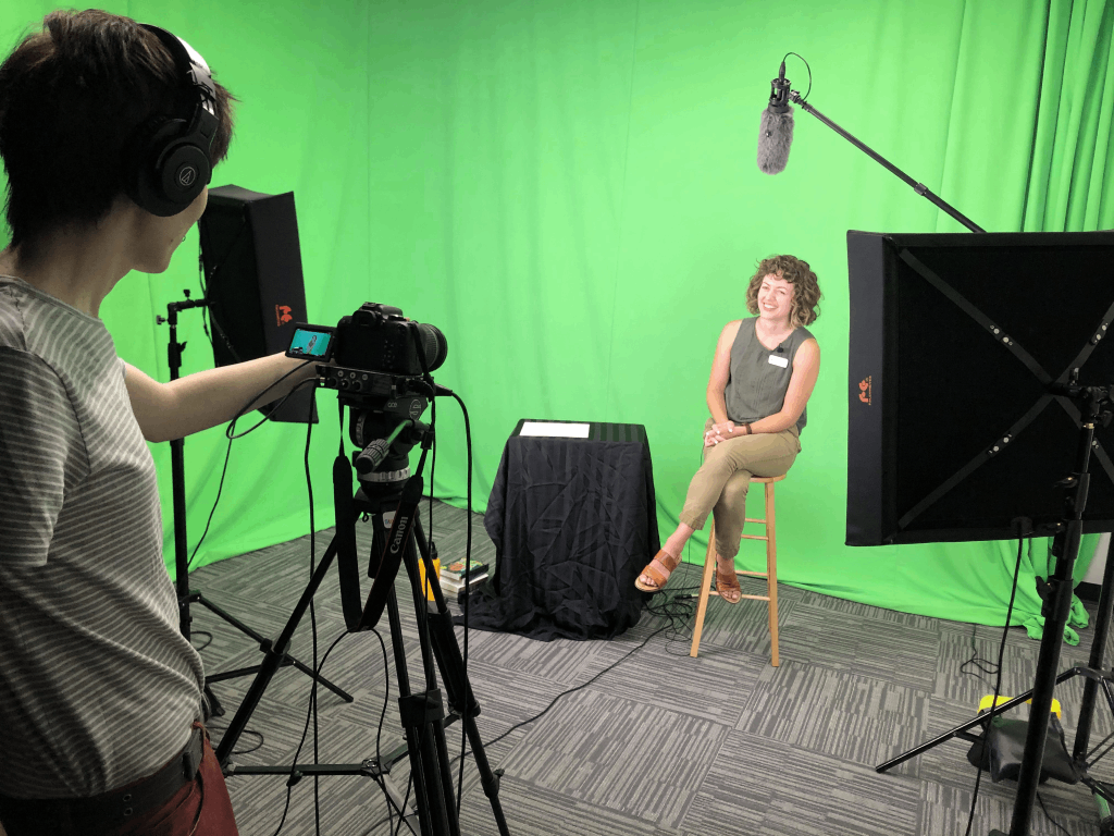 A librarian shooting a video on the StoryLab greenscreen.